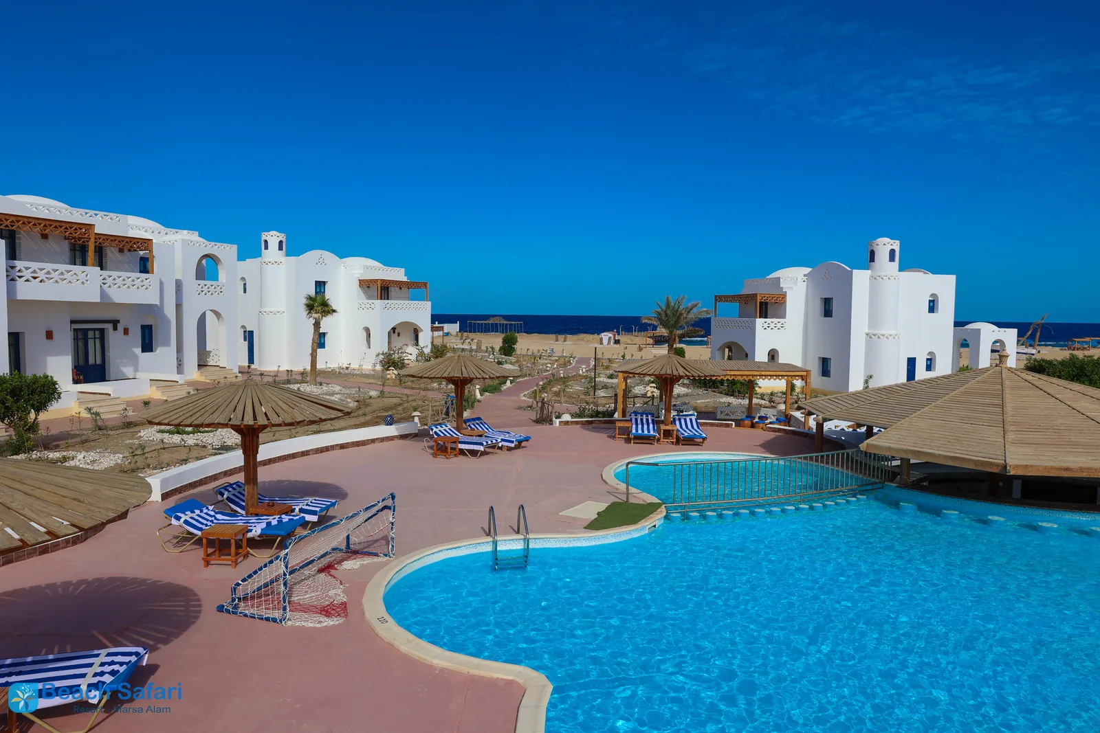 White Nubian-style buildings, pool and Red Sea at Beach Safari Resort